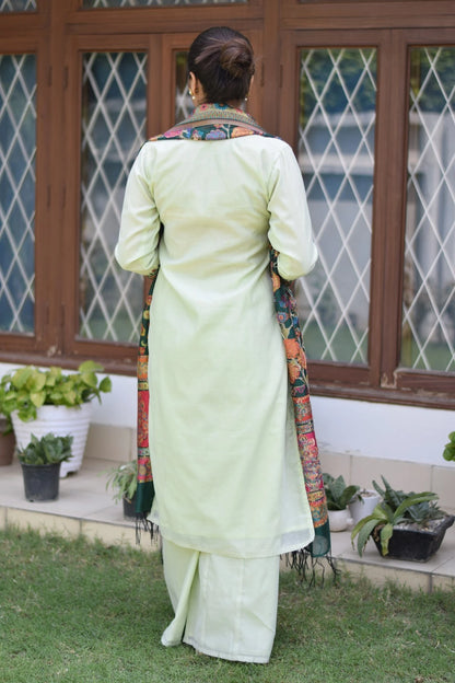 A traditional green outfit with a silk jamawar dupatta, chanderi resham embroidered kurta, and palazzo.