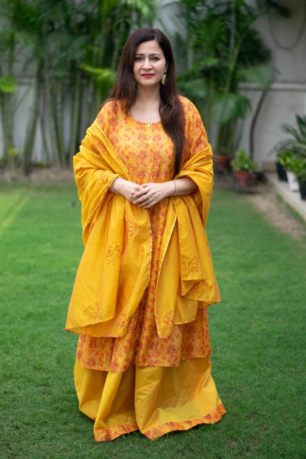 Vibrant yellow Chanderi Kurta on a woman with intricate gold embroidery. 
