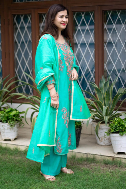 An exquisite sea green zari kurta featuring intricate beadwork.