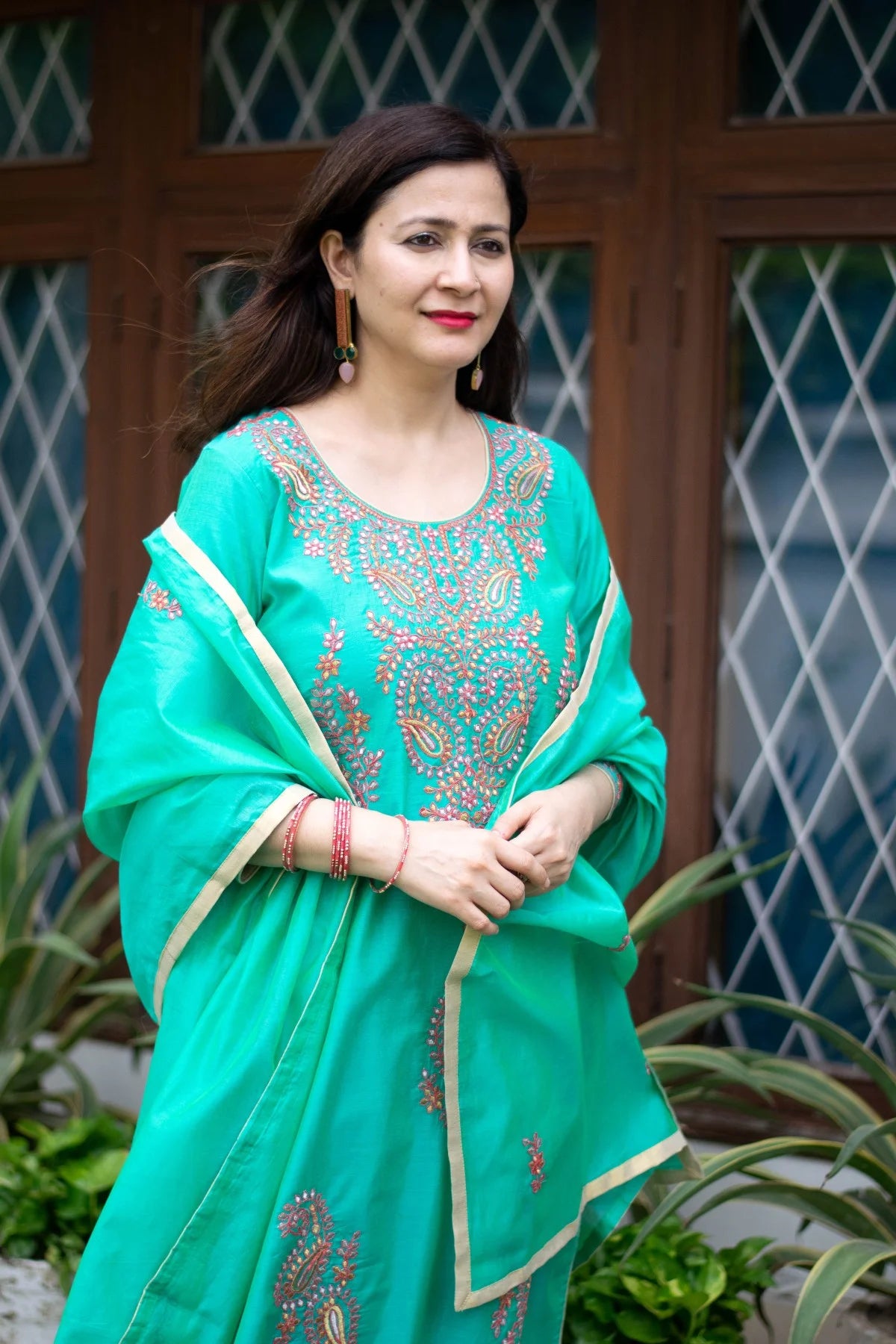 A beautiful sea green zari kurta adorned with golden threadwork.