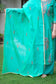 A stylish sea green zari kurta paired with contrasting red churidar pants.