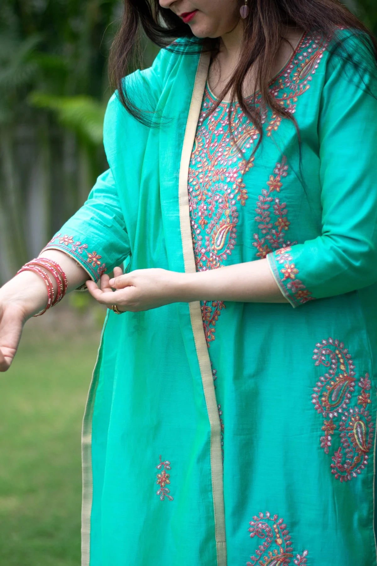 An elegant sea green zari kurta with a floral pattern.