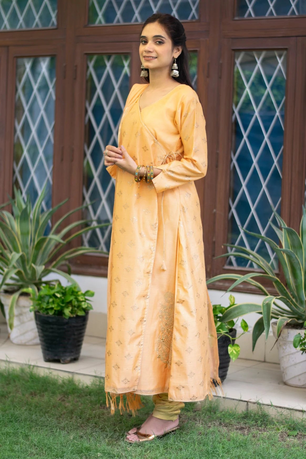 This peach angarkha kurta is a perfect blend of elegance and style, as worn by an Indian woman.