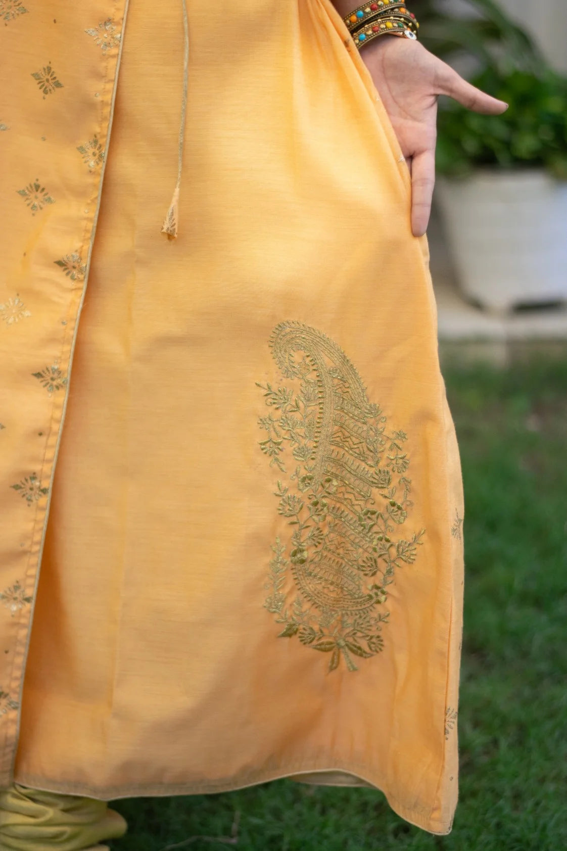 A traditional yet trendy peach angarkha kurta, as seen on an Indian woman.