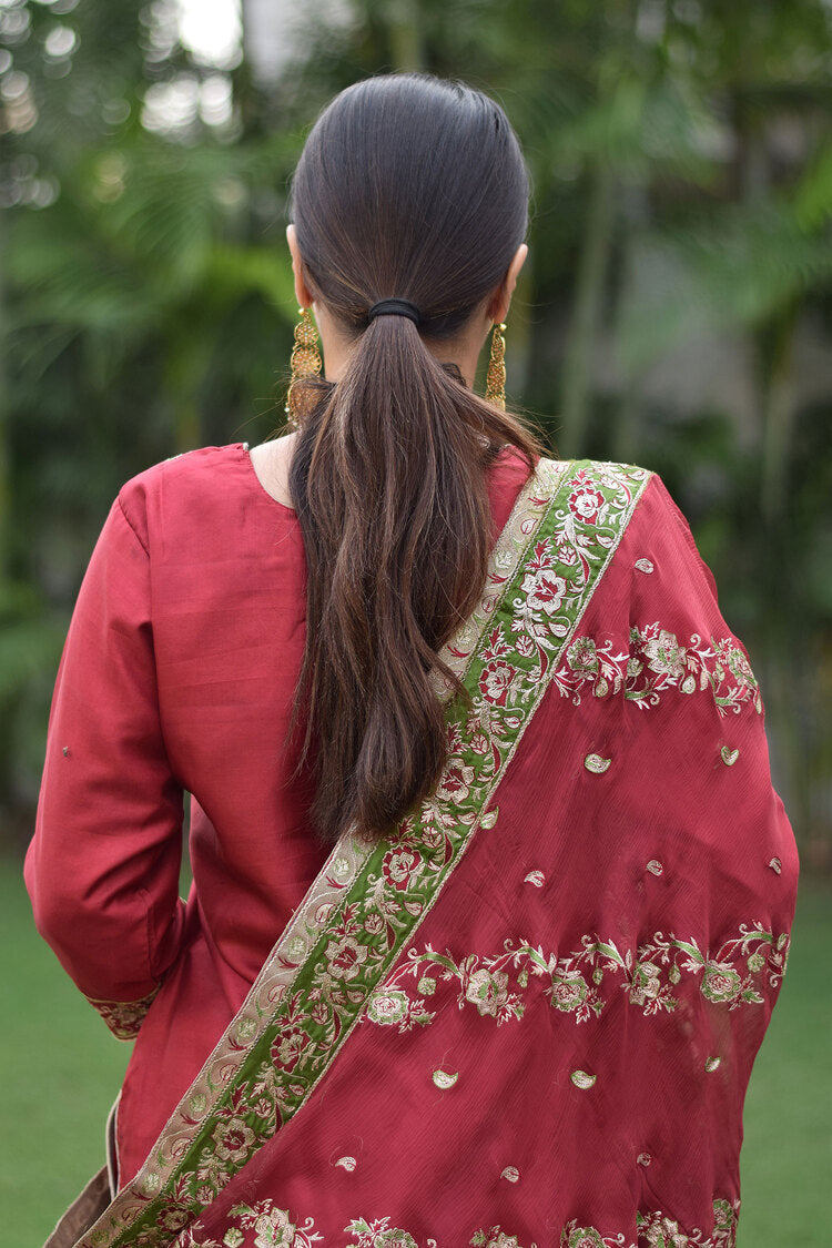 Woman wearing intricate Maroon Silk & Kamkhab Tilla Embroidered Gharara set