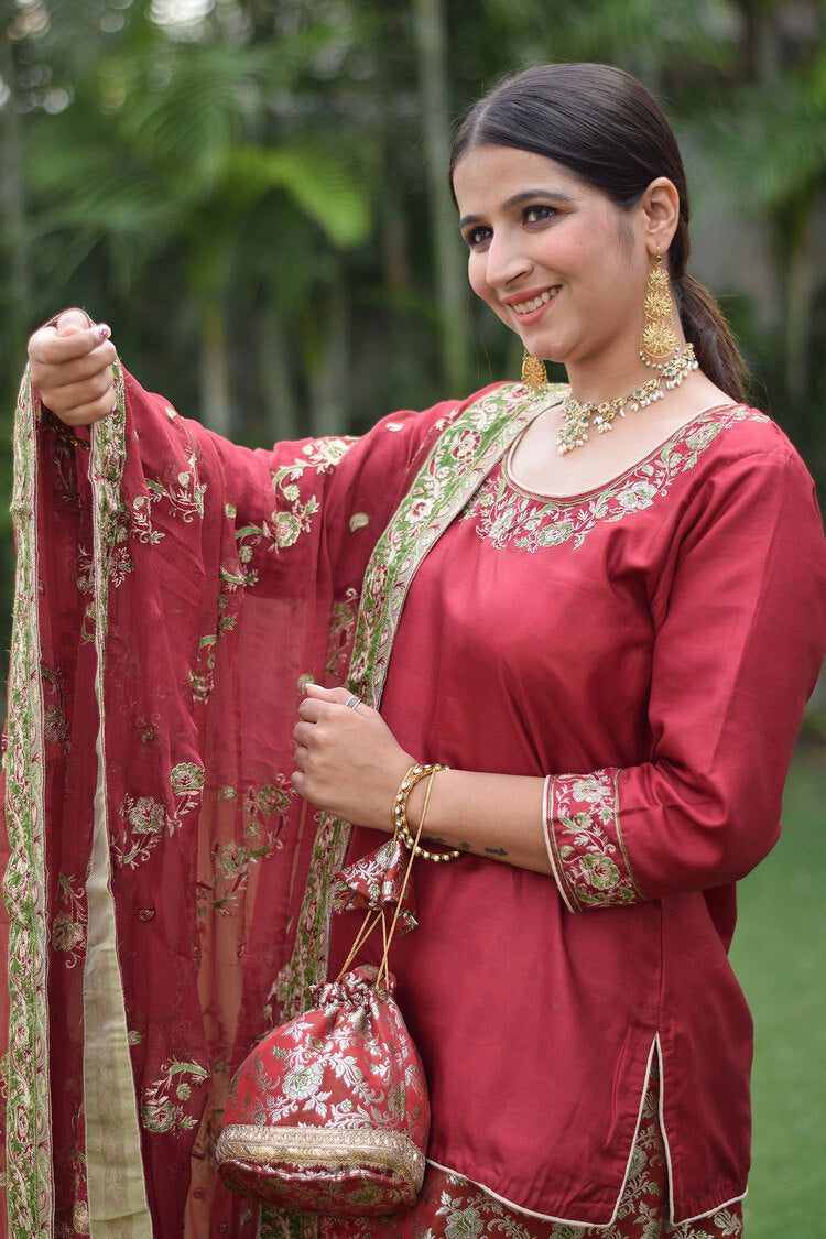 Stunning woman dressed in Maroon Silk & Kamkhab Tilla Embroidered Gharara set