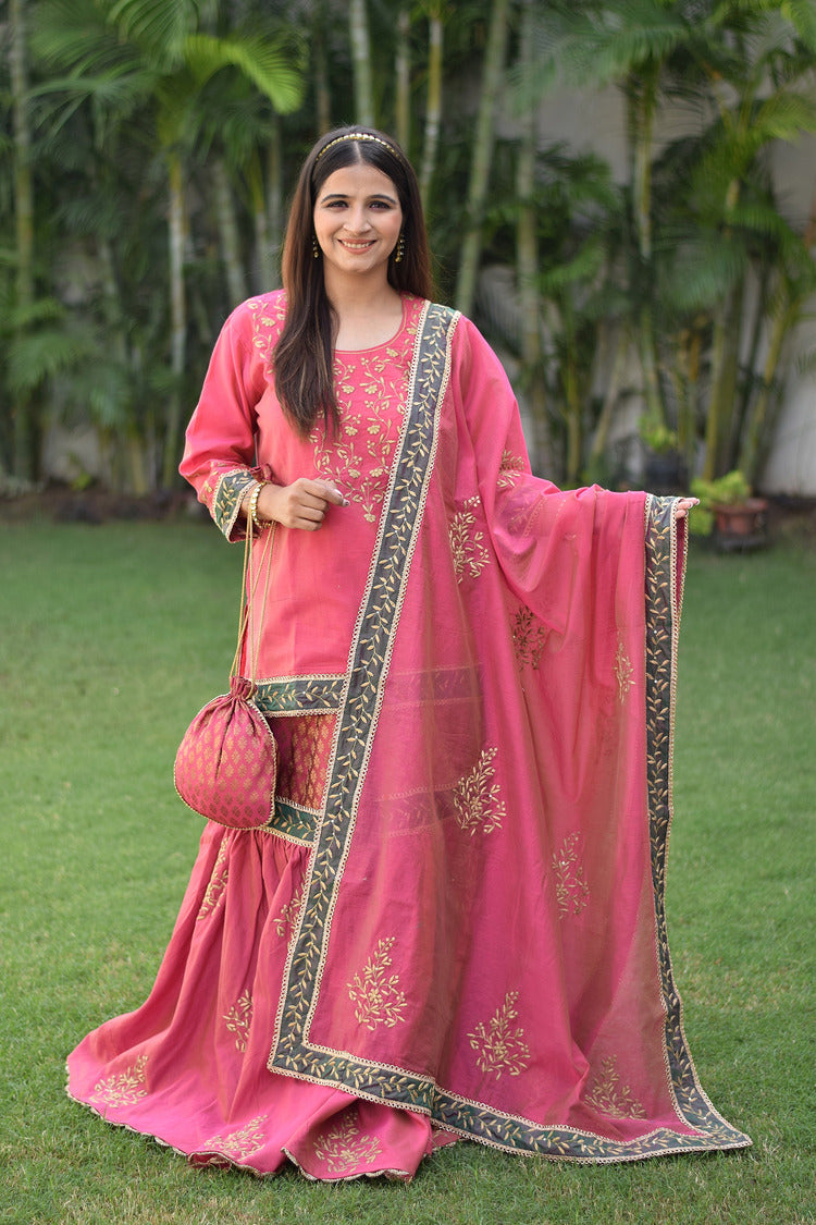 A vibrant fuchsia pink Chanderi Gharara set adorns a beautiful woman with stunning Aari and tissue applique work.
