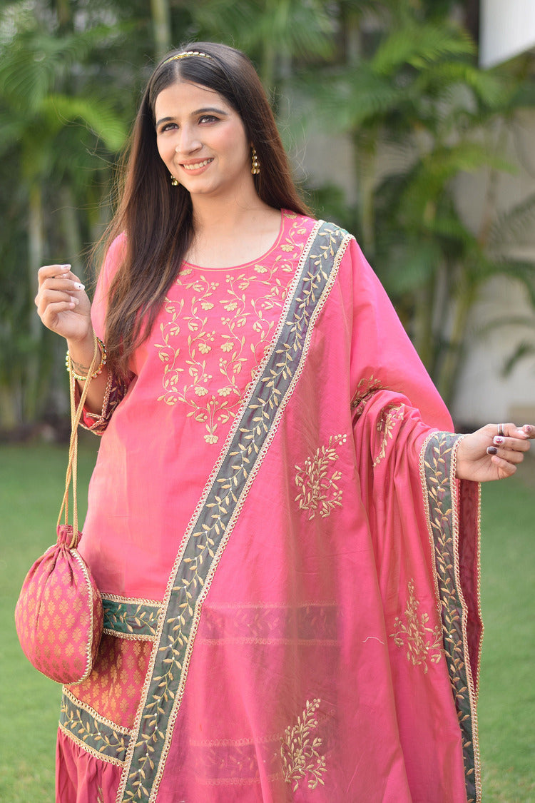 A lady looks gorgeous in her fuchsia pink Chanderi Gharara set featuring stunning Aari and tissue applique work.