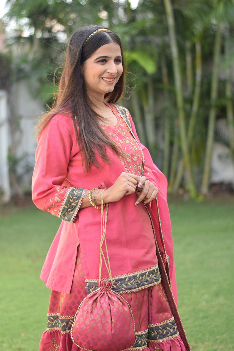 A stunning fuchsia pink Chanderi Gharara set adorns a lady with intricate Aari and tissue applique work.