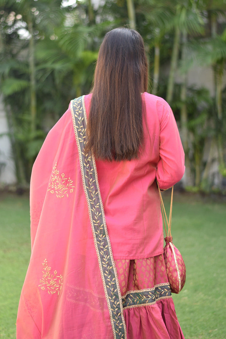 A beautiful woman looks fabulous in her fuchsia pink Chanderi Gharara set with stunning Aari and tissue applique work.