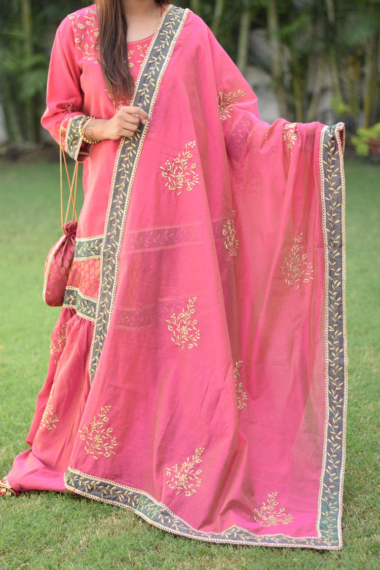 A beautiful woman looks stunning in her fuchsia pink Chanderi Gharara set with gorgeous Aari and tissue applique work.