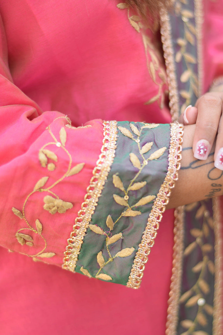 A beautiful woman looks fabulous in her fuchsia pink Chanderi Gharara set with exquisite Aari and tissue applique work.
