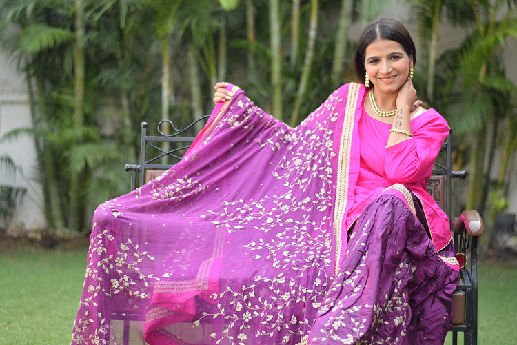 A woman donning a beautiful Purple and Magenta Silk Applique Gharara set.