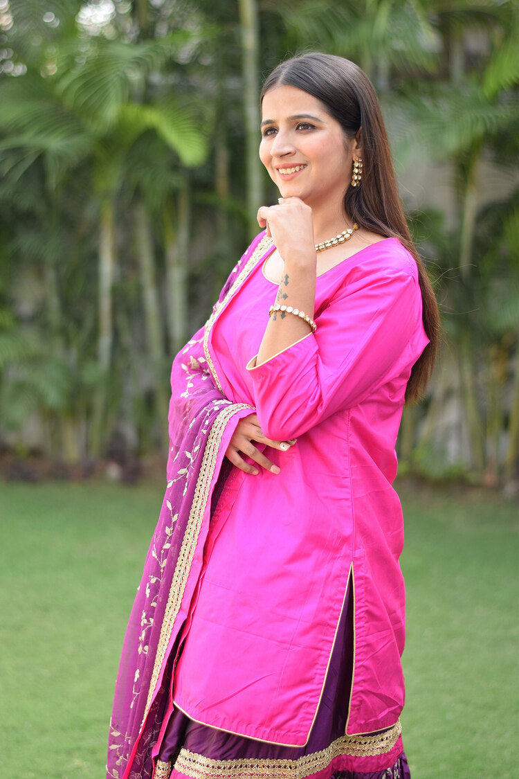 An elegant lady in a Purple and Magenta Silk Applique Gharara set.
