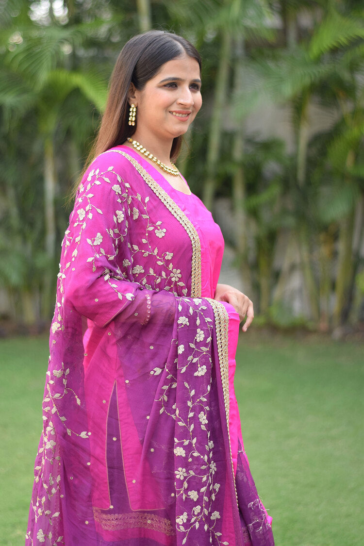 A woman looking ravishing in her Purple and Magenta Silk Applique Gharara set.