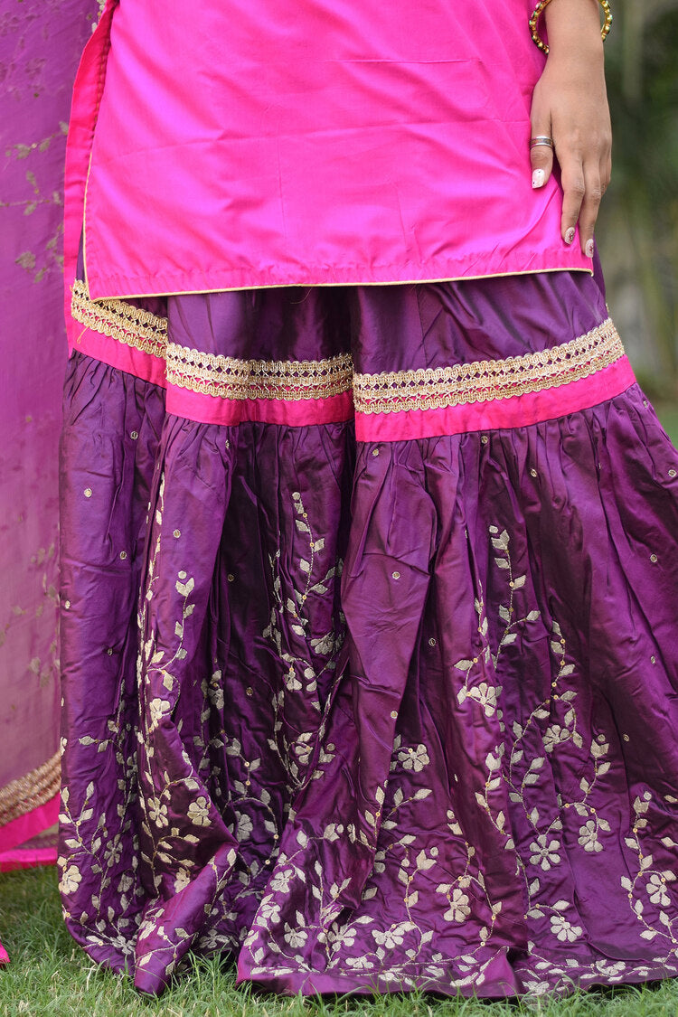 A gorgeous woman wearing a traditional Purple and Magenta Silk Applique Gharara set.