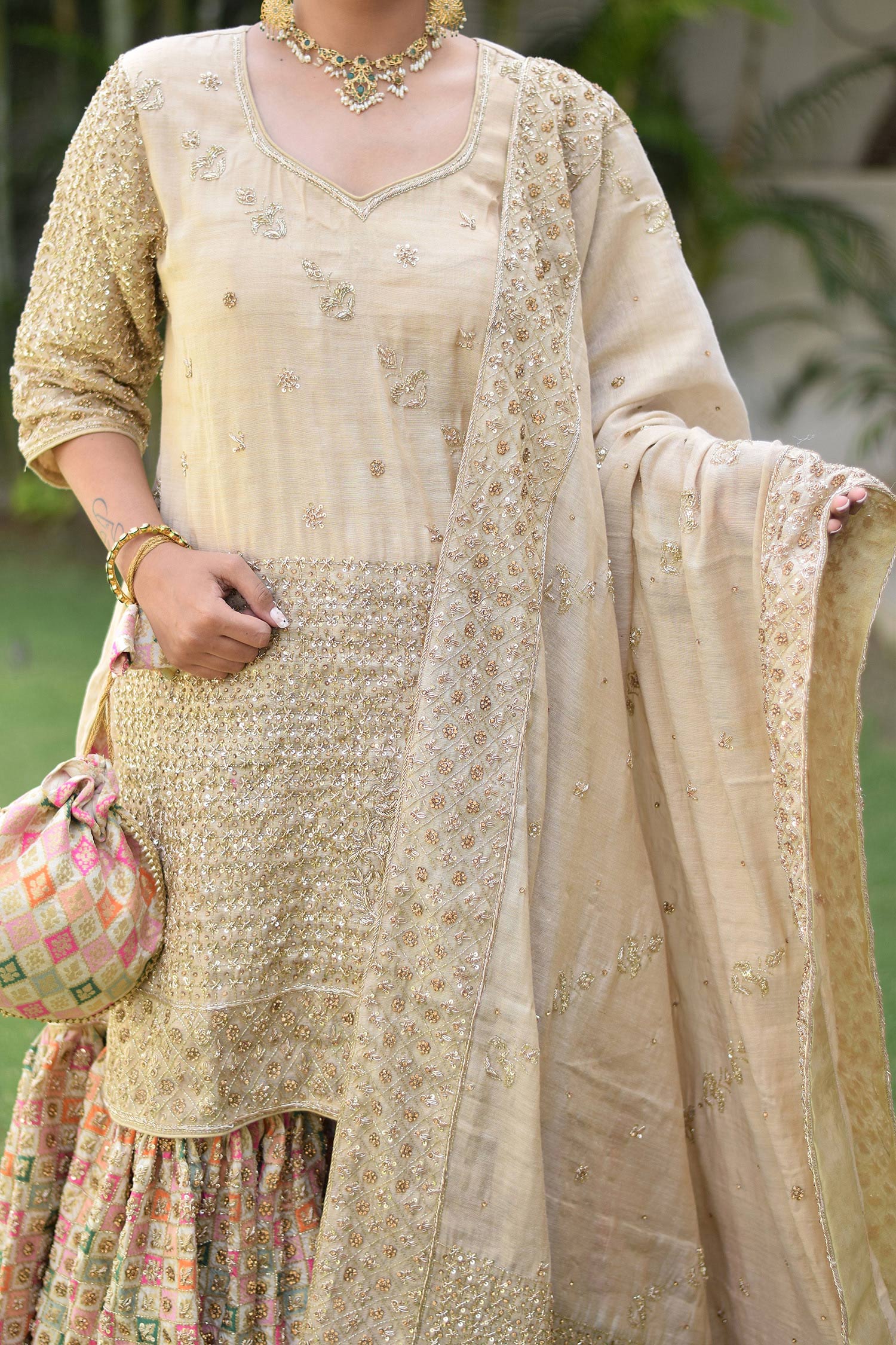 Indian women wearing Brocade Gharara with dupatta and pouch