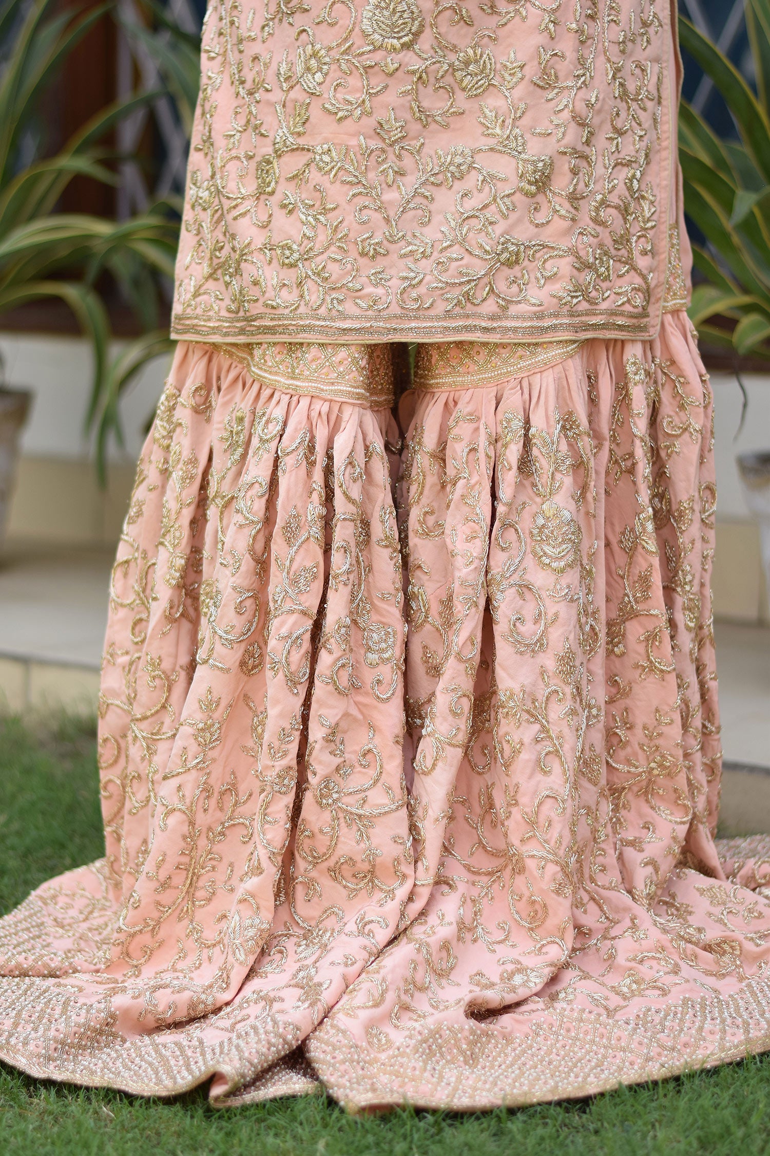 Traditional yet trendy outfit featuring Peach Crepe Silk Zardozi Jaal Work Gharara Set