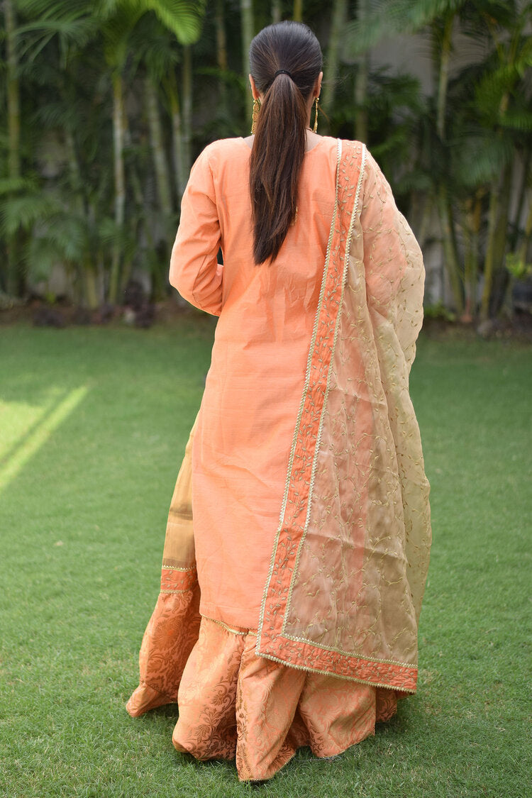 An elegant Peach Kamkhab Farshi Gharara, Peach Chanderi Kurta & Golden Dupatta with Tissue Applique Work outfit for women