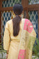 A beautiful ensemble featuring a pink and green patchwork Chanderi dupatta, worn with a golden kurta and palazzo pants.