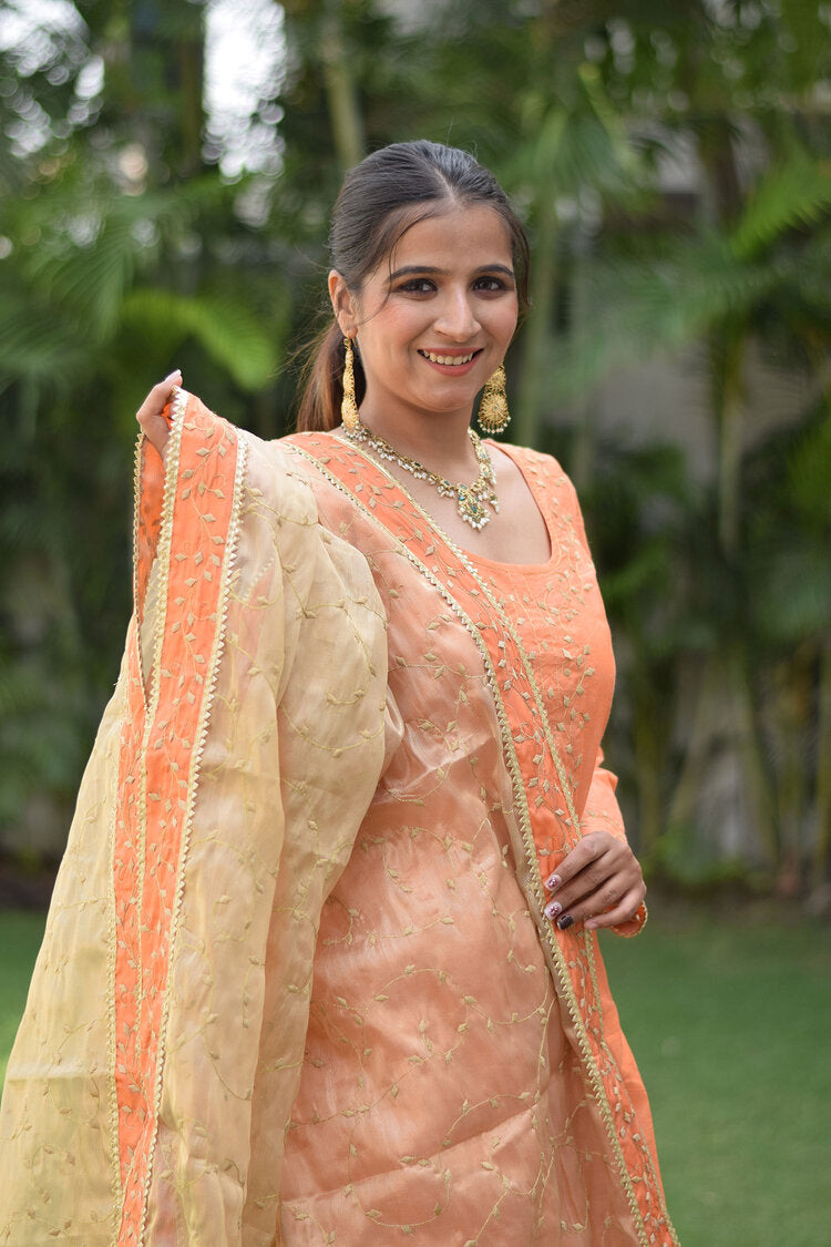 A traditional Indian Peach Kamkhab Farshi Gharara, Peach Chanderi Kurta & Golden Dupatta with Tissue Applique Work attire