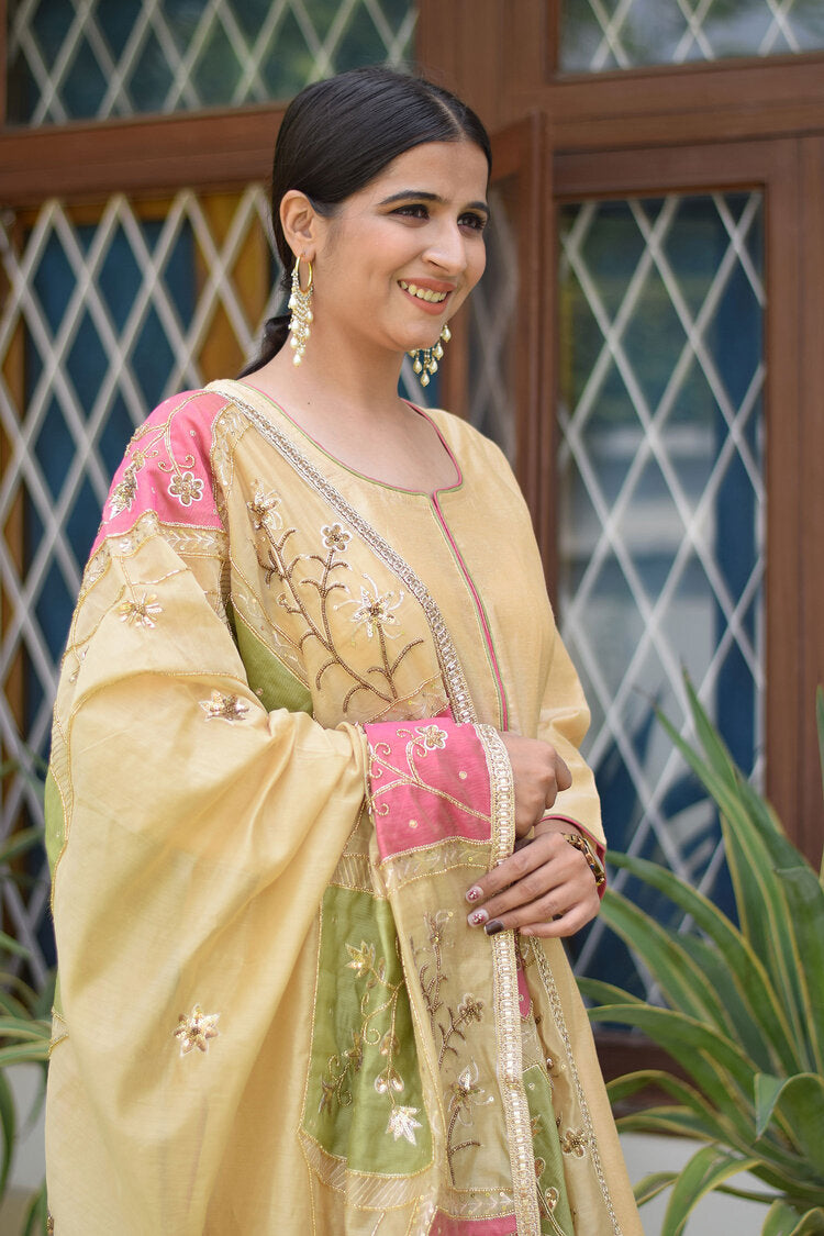 A colorful ensemble consisting of a pink and green patchwork Chanderi dupatta, golden kurta, and palazzo pants.