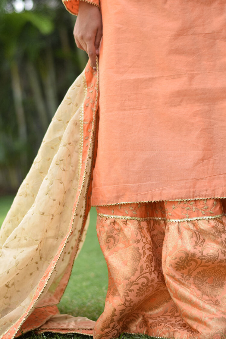A regal Peach Kamkhab Farshi Gharara, Peach Chanderi Kurta & Golden Dupatta with Tissue Applique Work attire