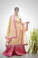 A lady dressed in a gorgeous traditional outfit consisting of a Magenta Kamkhab Farshi Gharara and Golden Chanderi Kurta & Dupatta with Tissue Applique Work.