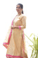 A lady dressed in a captivating Magenta Kamkhab Farshi Gharara, Golden Chanderi Kurta & Dupatta with Tissue Applique Work.