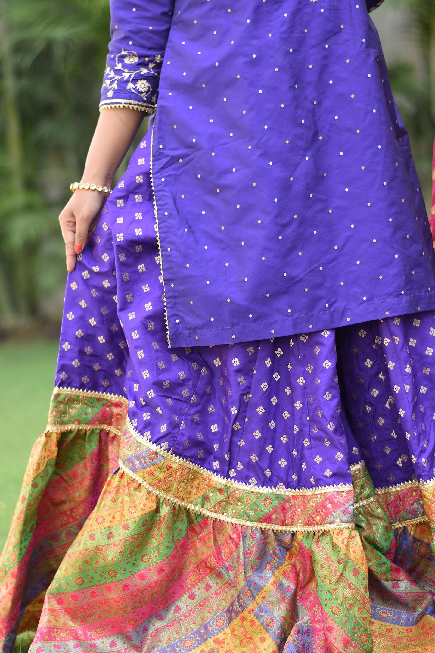 A woman showing bottom design for Purple Silk & Multicolored Brocade Farshi Gharara Set