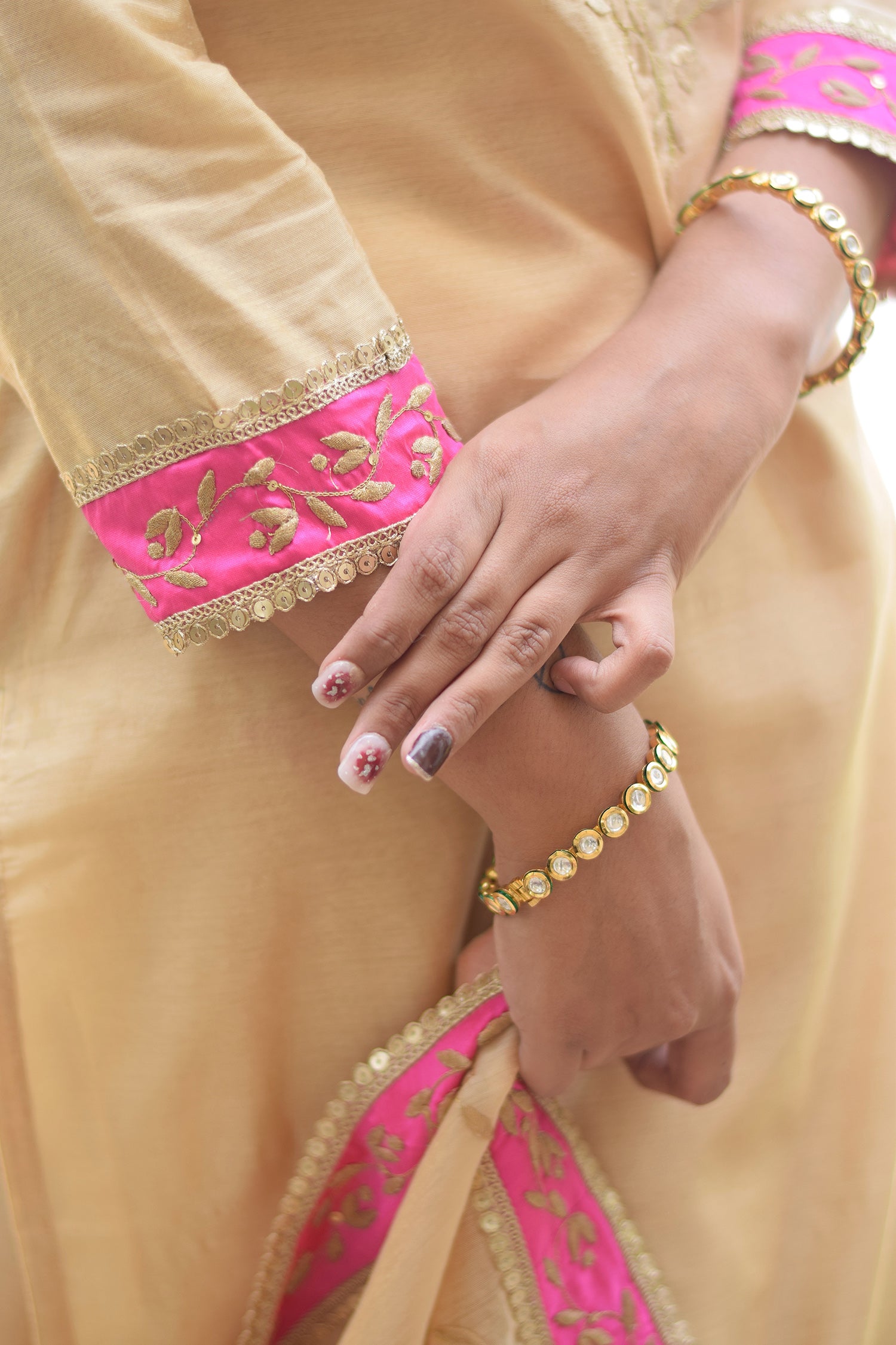 A stunning outfit of a Magenta Kamkhab Farshi Gharara, Golden Chanderi Kurta & Dupatta with Tissue Applique Work, worn by a beautiful woman.