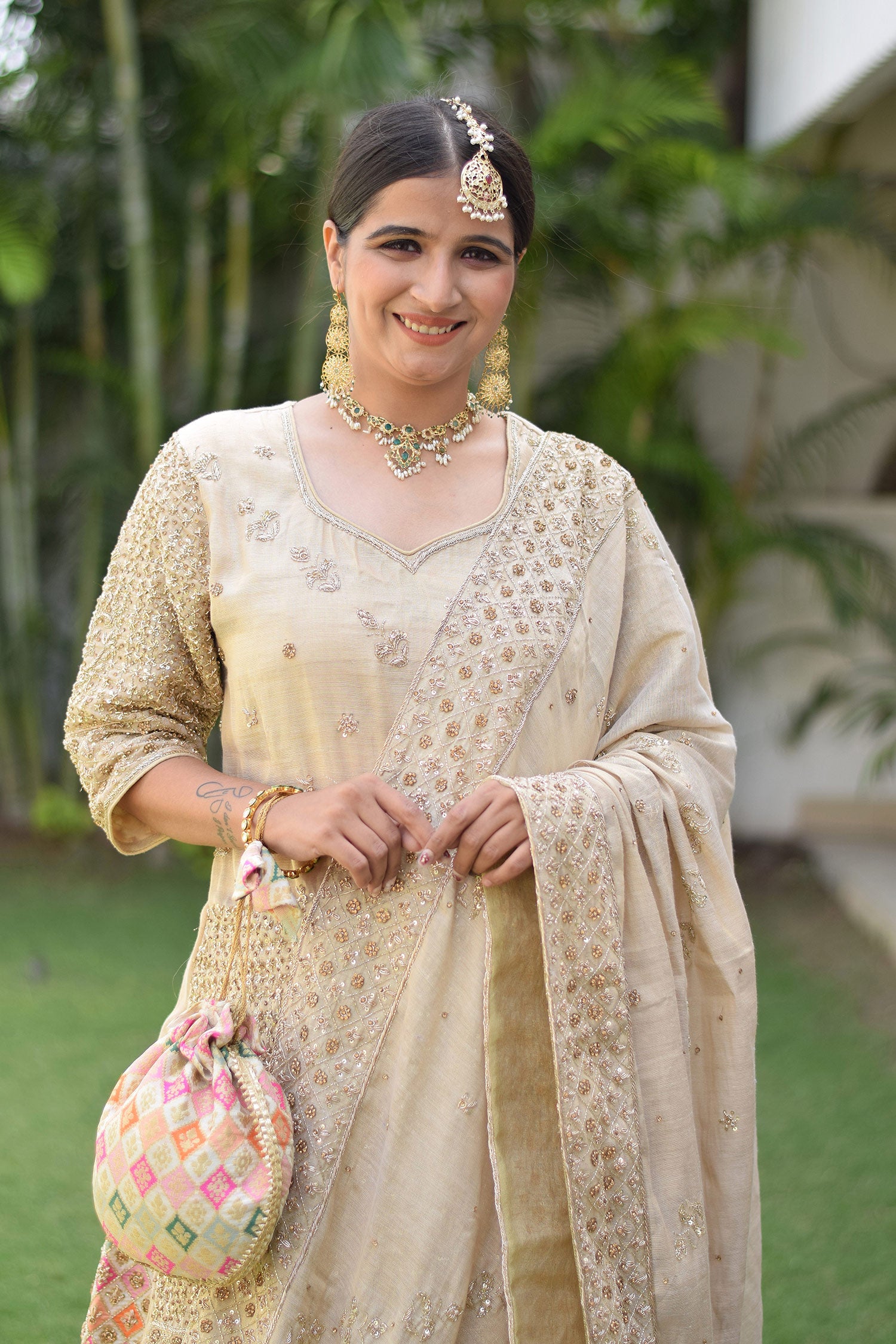 Golden bridal gharara suit with zardozi work