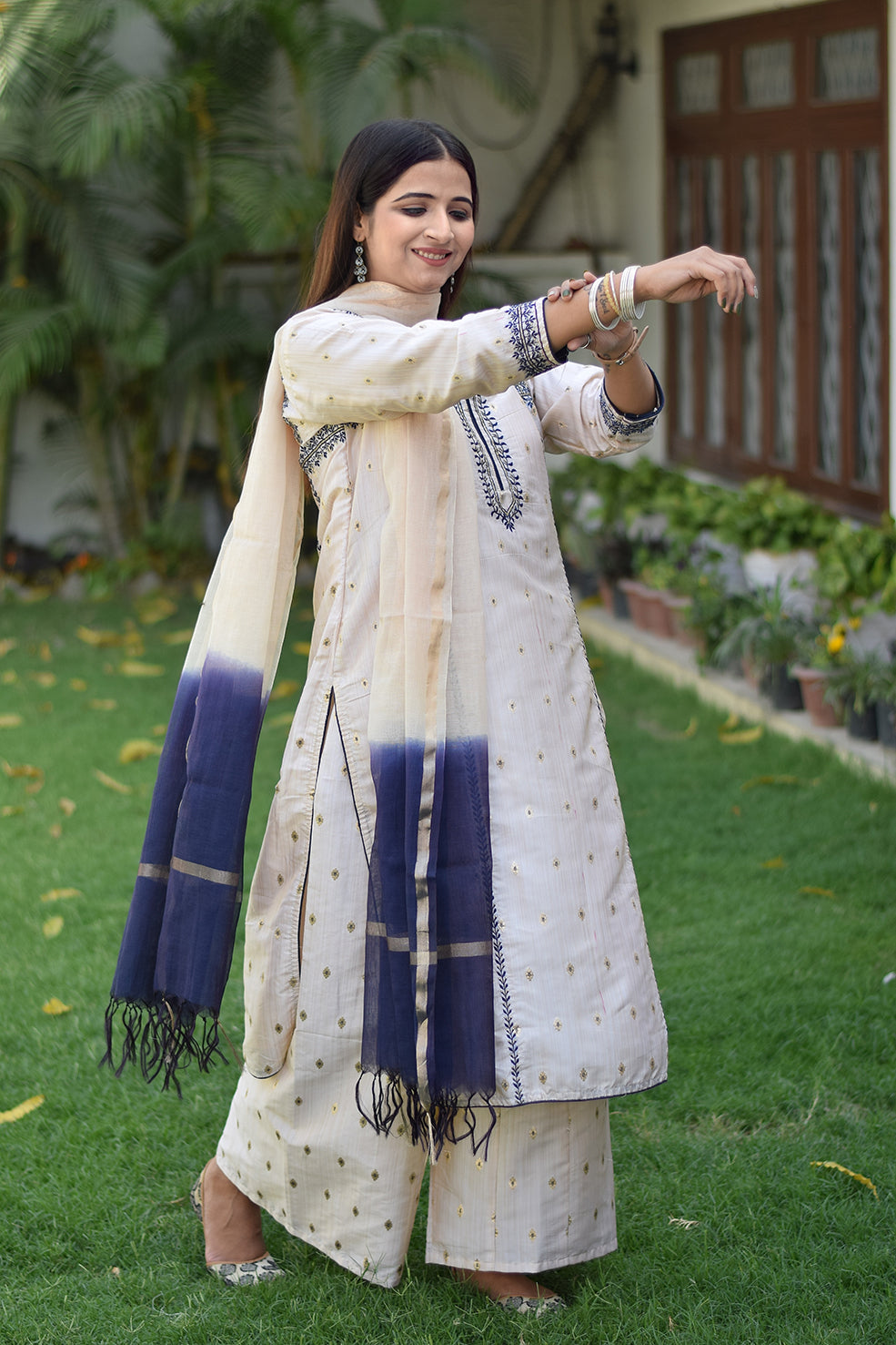 A traditional Indian outfit consisting of an Off-White Silk Kurta worn by a woman.
