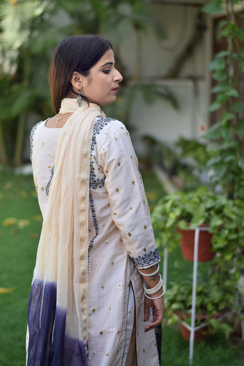 An elegant Indian woman in a beautifully designed Off-White Silk Kurta.