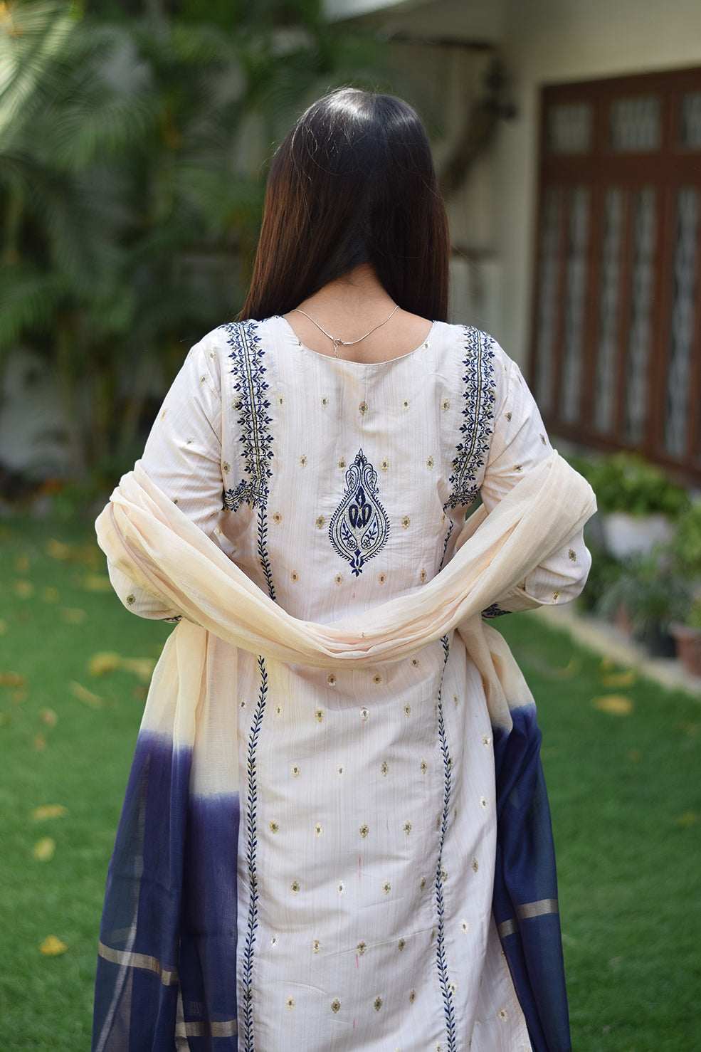 An image of an Indian woman in an Off-White Silk Kurta with stunning details and patterns.