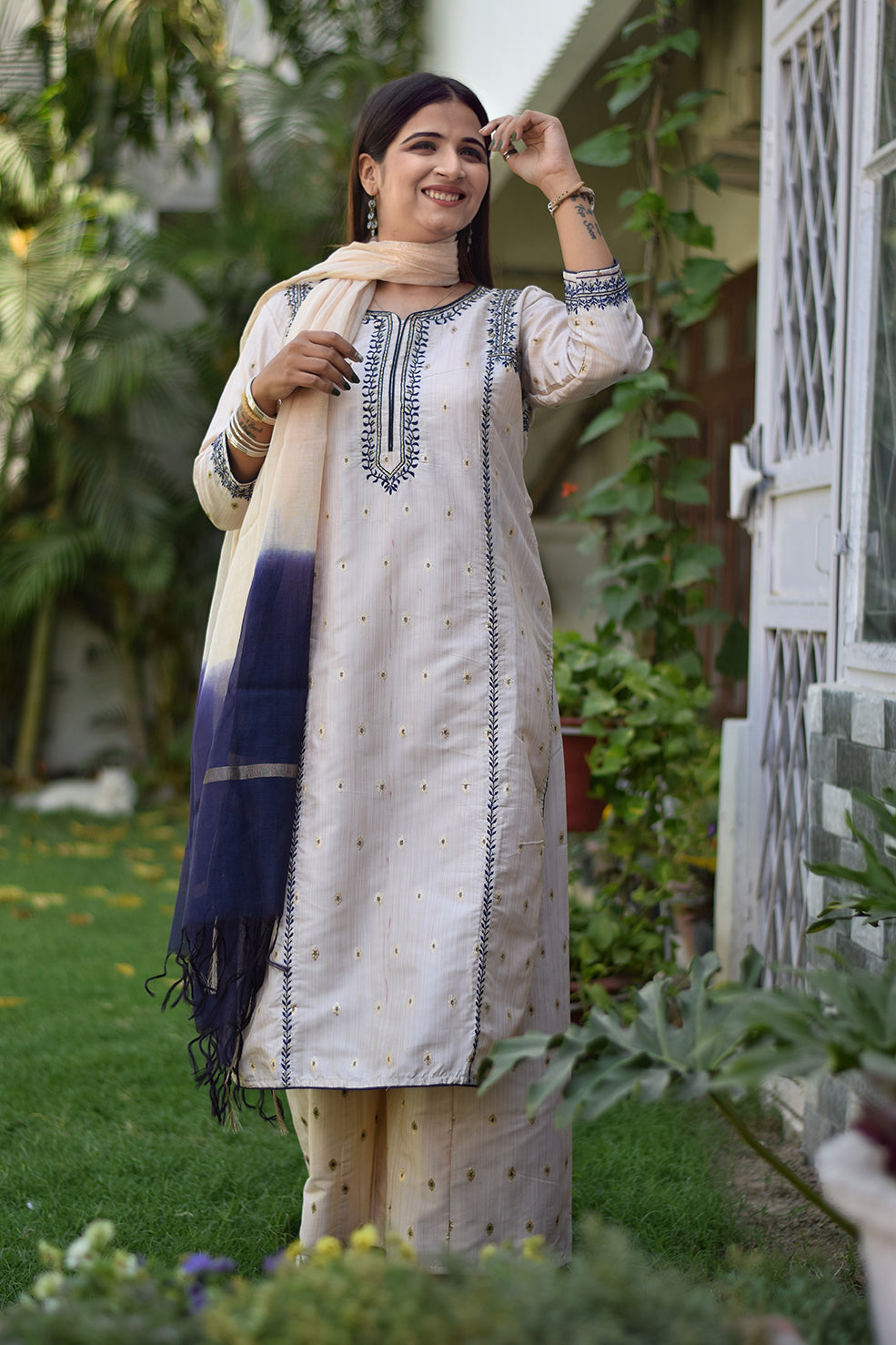 A picture of an Indian woman in an Off-White Silk Kurta with a flared bottom.