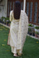 A woman wearing a traditional beige chanderi kurta and dupatta with contemporary beige trousers.
