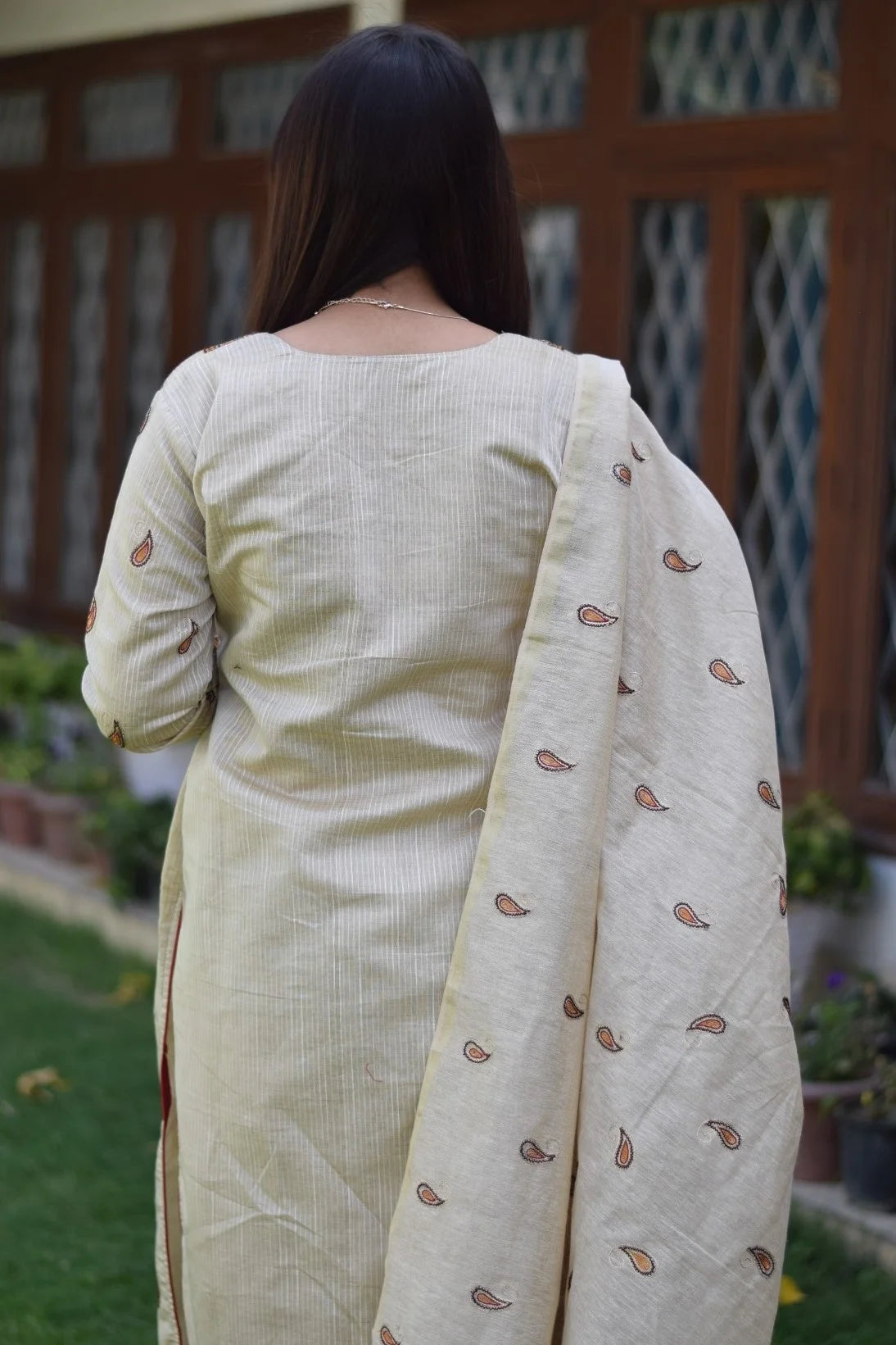 A stylish woman wearing a beige chanderi kurta and dupatta with matching beige trousers.