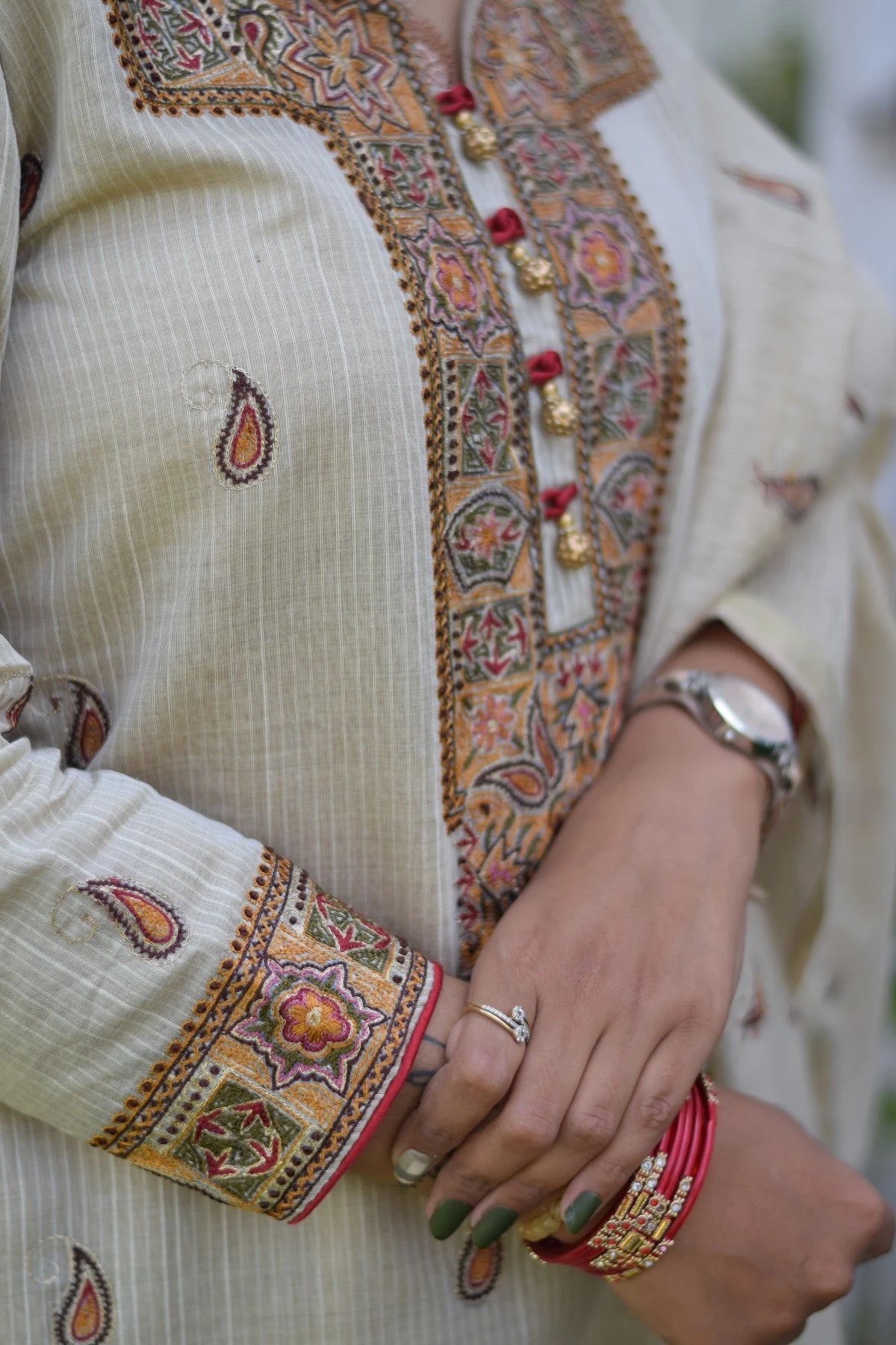 A woman wearing a beige chanderi kurta and dupatta with tapered beige trousers.