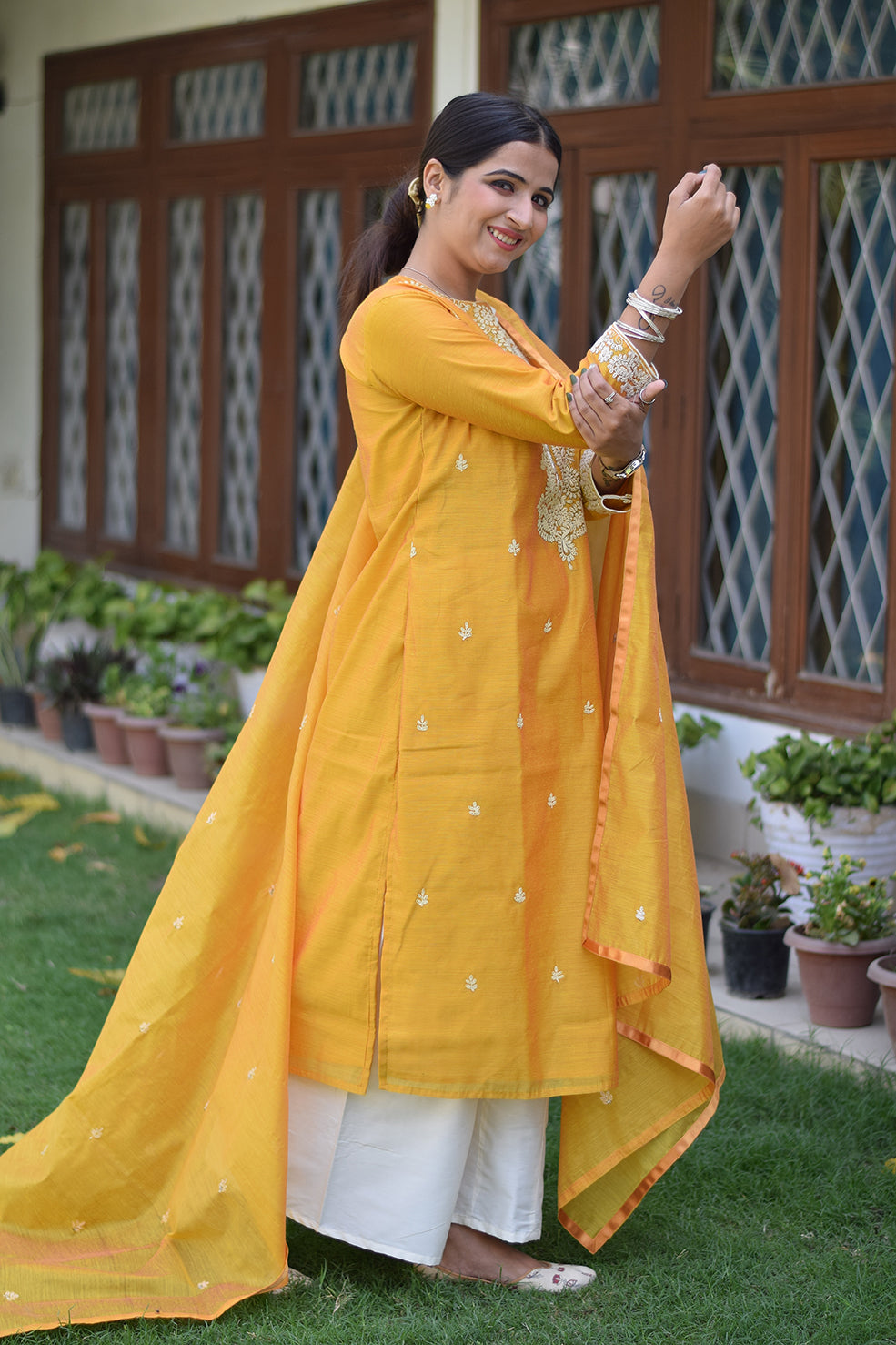 Indian women wearing yellow party wear kurta palazzo set