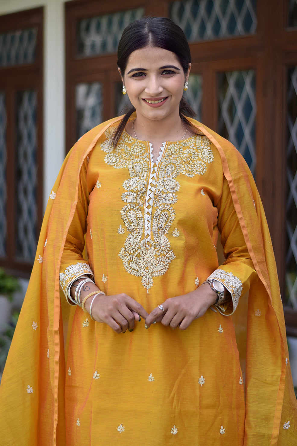 indian women wearing yellow kurta and palazzo set