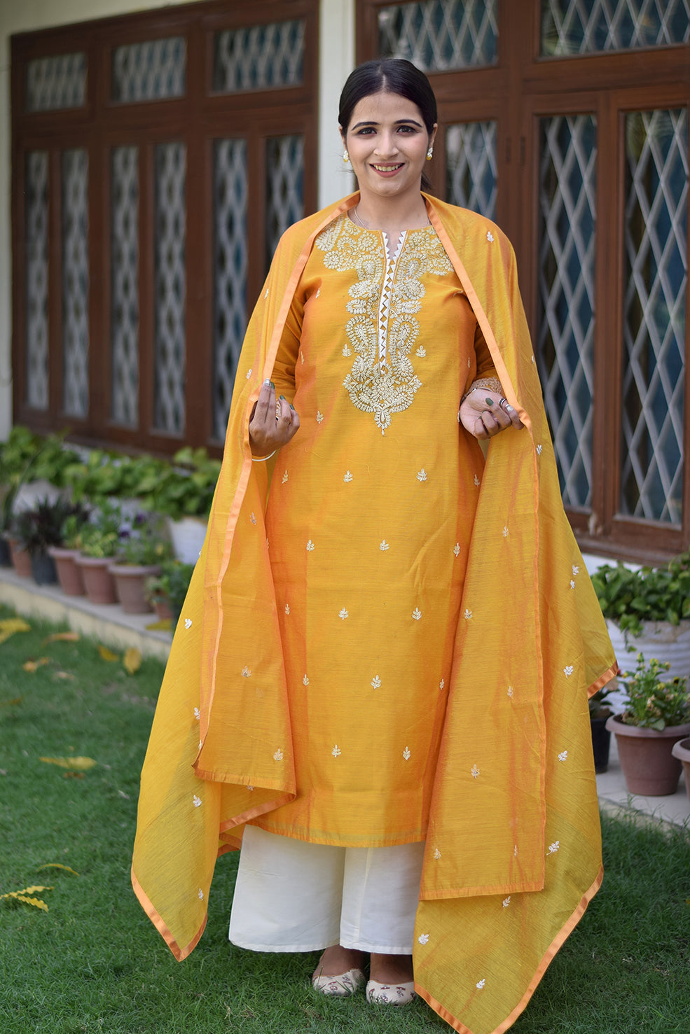 Indian women wearing yellow designer kurta palazzo set