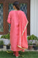 An elegant lady in a delicate pink jute kurta and churidar pants.