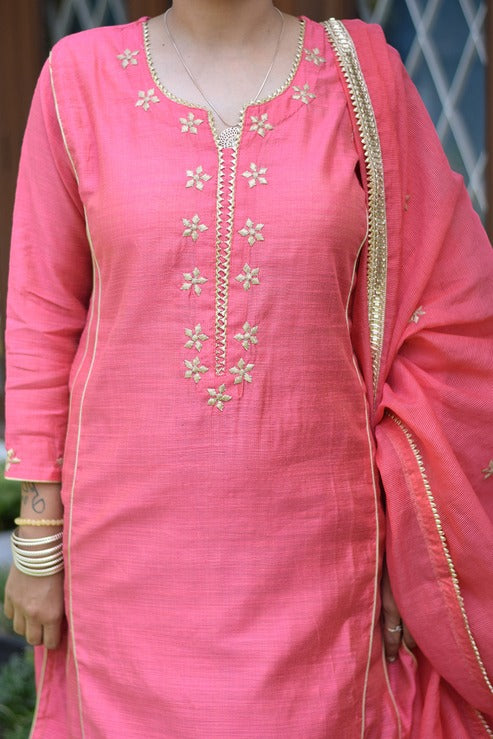 A radiant lady dressed in a stunning pink jute kurta with churidar pants.