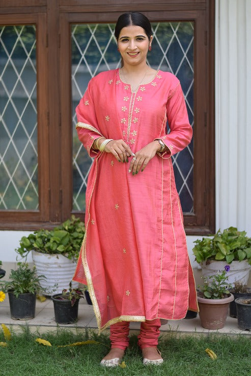 An elegant Indian woman in a beige jute kurta and matching pants.