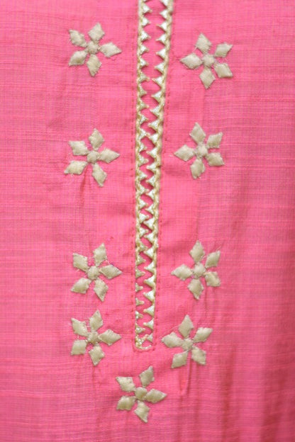 A stylish Indian woman wearing a fashionable pink jute kurta and churidar.