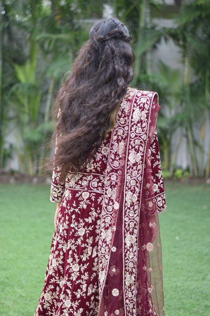 The Trail Gown in maroon is a timeless piece that captures the essence of Indian fashion, as seen on this elegant woman.