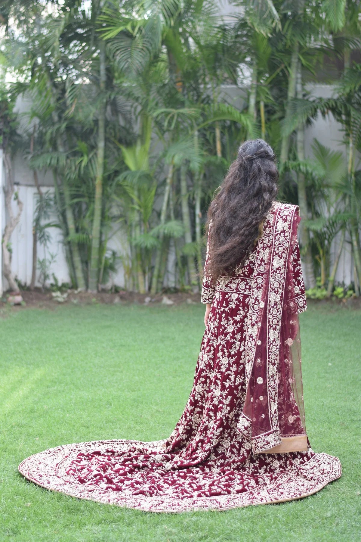 This Trail Gown in maroon is a showstopper, as evidenced by the way it flatters the curves of this Indian woman.
