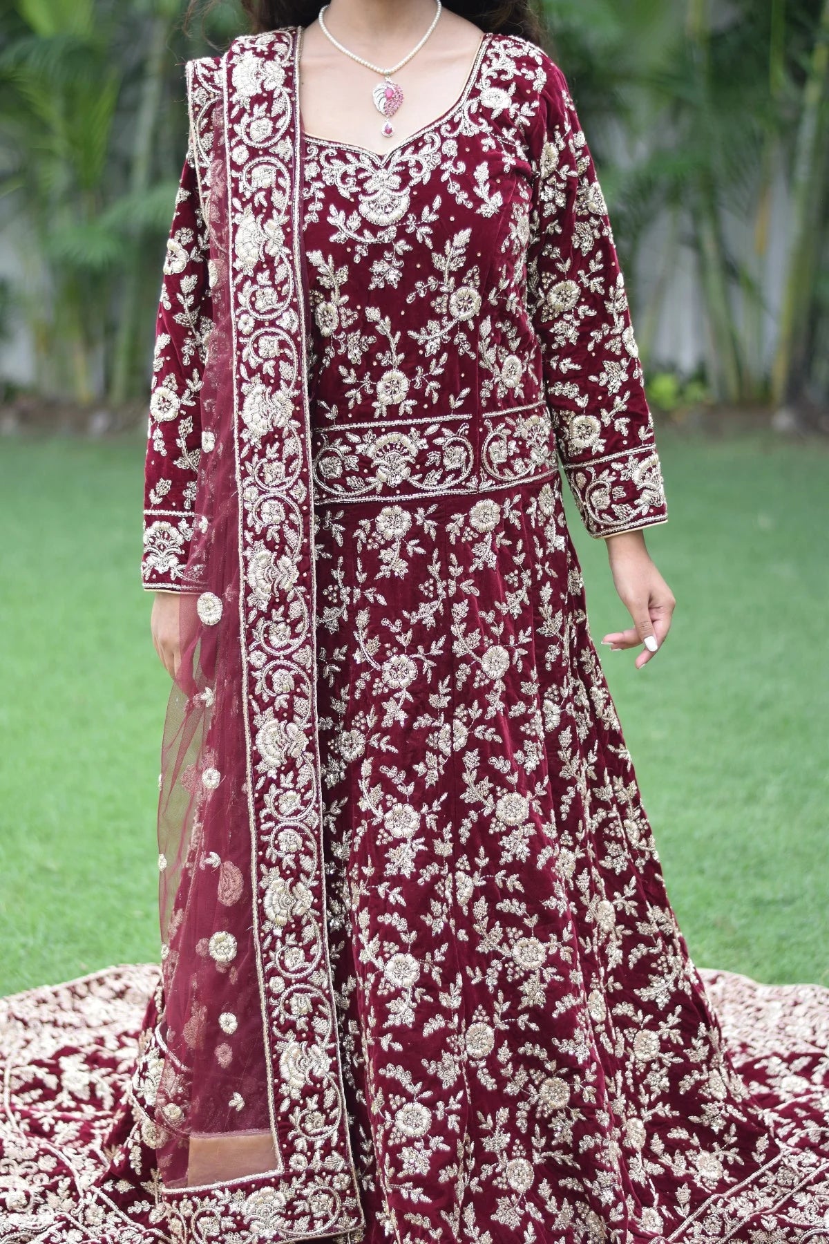 The Trail Gown in maroon is a versatile choice for Indian women, as demonstrated by how this woman pairs it with statement jewelry and bold makeup.