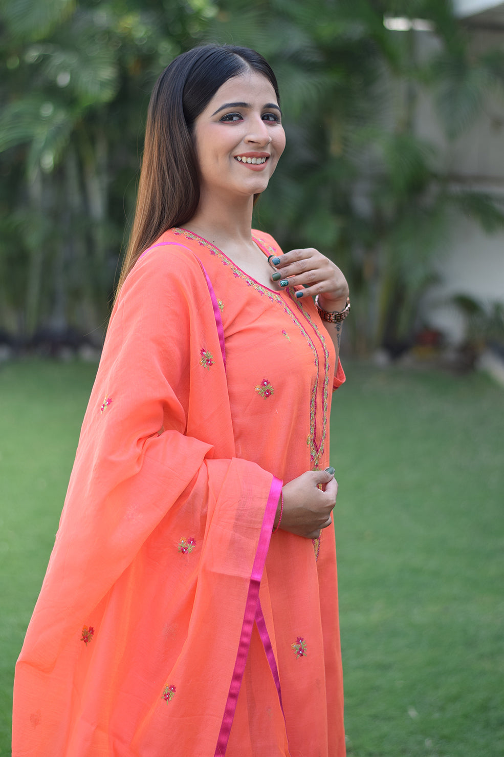 This ensemble features a peach chanderi kurta and dupatta with intricate embroidery, paired with peach trousers on a female model.